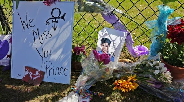 Tributes and memorials dedicated to Prince lie near the fence that surrounds Paisley Park.
