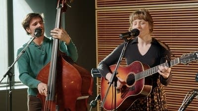 Two musicians performing together in a recording studio