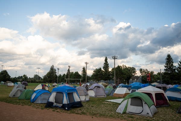 A tent staging area on football field