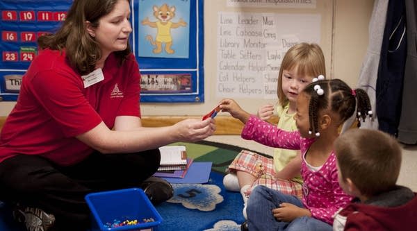Kristen Southard, a pre-kindergarten teacher, sits with her students at the Breezewood KinderCare Learning Center in Fredericksburg, Virginia. 