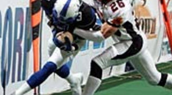 Will Houlder of the New York Dragons tackles Will Pettis of the Dallas Desperados during an Arena Football League game in 2007.