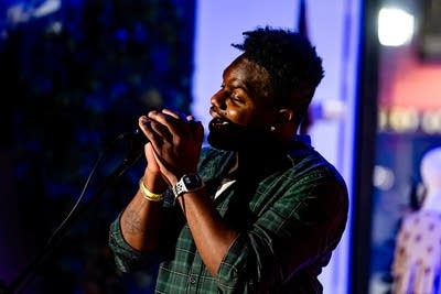 A musician sings onstage in a music venue