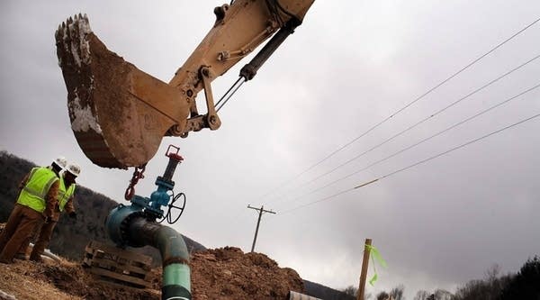 Cabot Oil and Gas employees work in South Montrose, Pennsylvania, on a natural gas valve at a hydraulic fracturing site in 2012. 