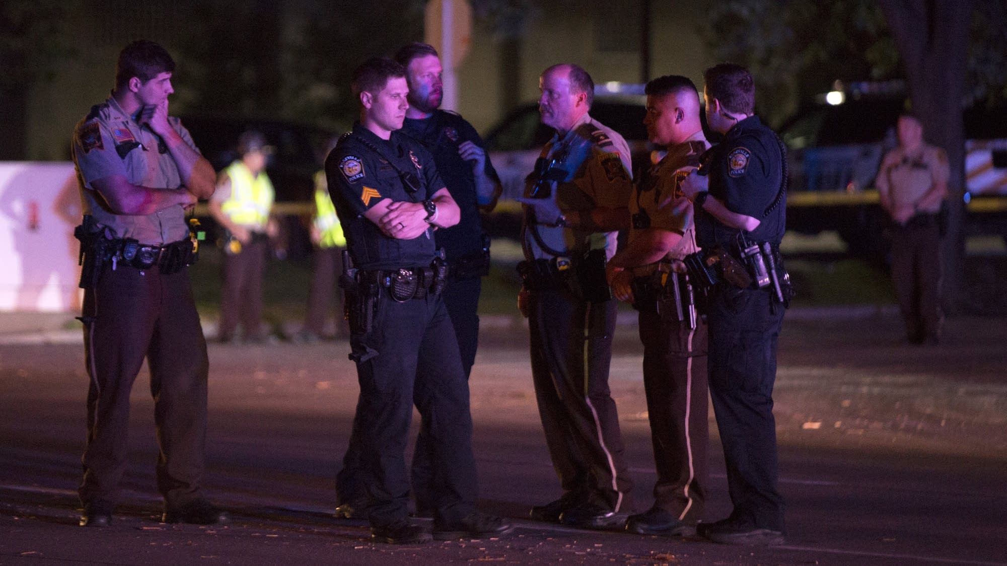 Officers gather at the scene of the shooting.