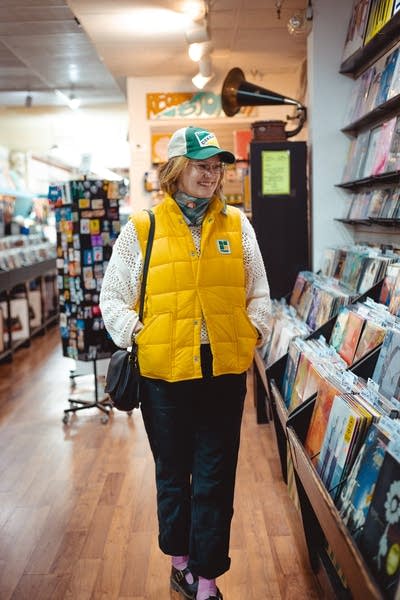 A woman browses records on display in a record store