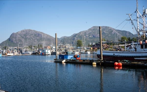 Boats in the water are the foreground; mountains are the background.
