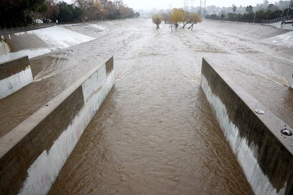 Rain falls as the Los Angeles River flows at a strong rate on Jan. 9, 2023 in Los Angeles, California.