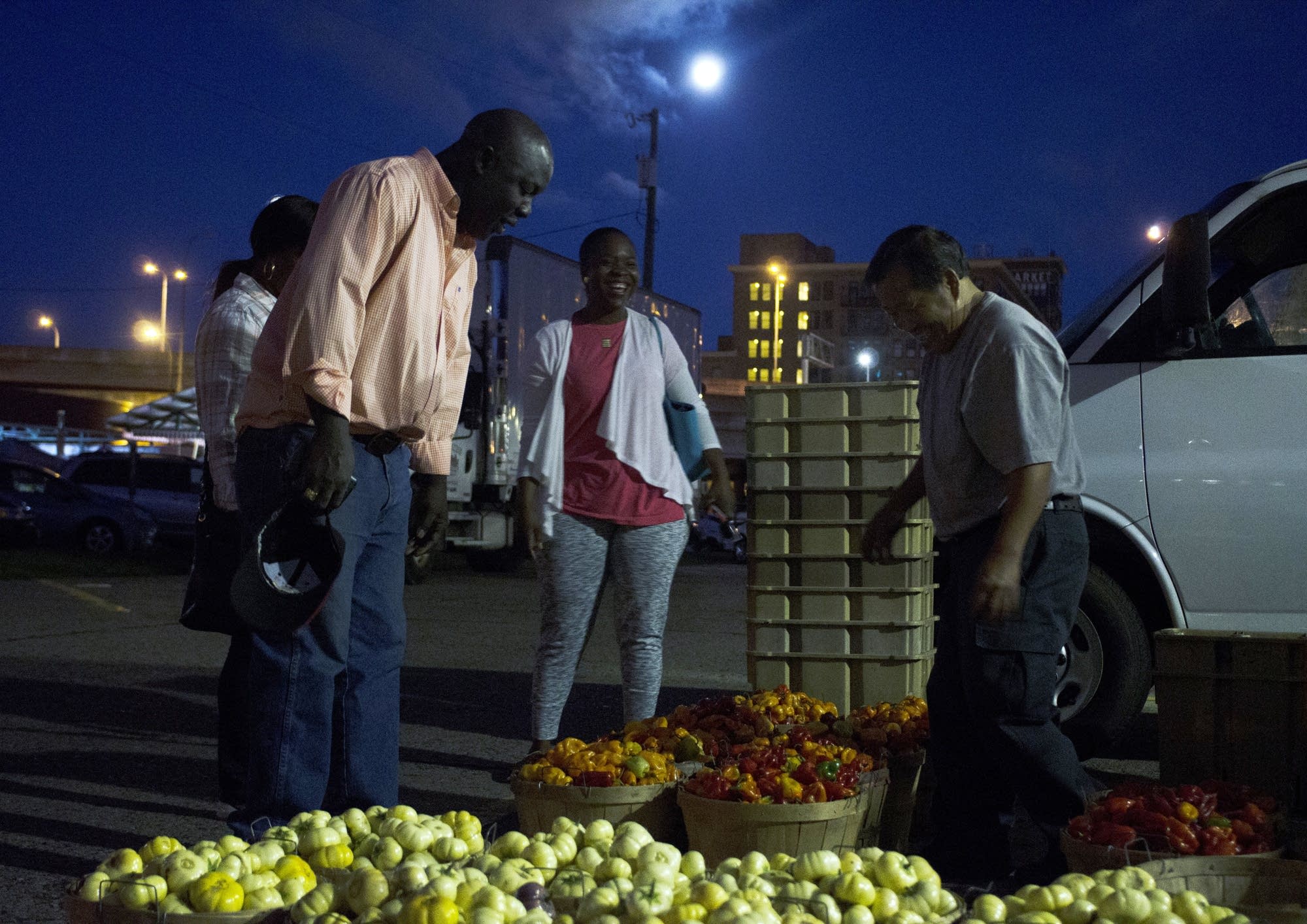 Blama Kollie inspects habaneros and bitterballs.