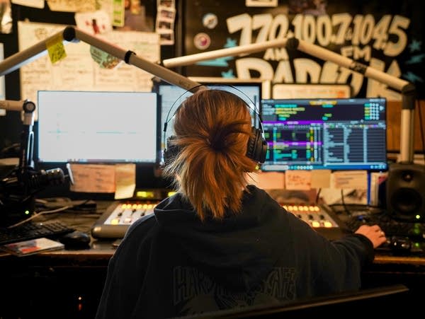 Claire Knudten, a Radio K DJ, sits in Radio K's studio during her on-air shift at Rarig Center in Minneapolis on Thursday, February 9, 2023.