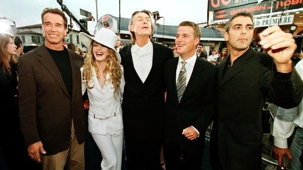Director Joel Schumacher (center) along with Arnold Schwarzenegger, Alicia Silverstone, Chris O'Donnell and George Clooney (left to right) at the premier for Batman & Robin. The director died Monday at age 80.