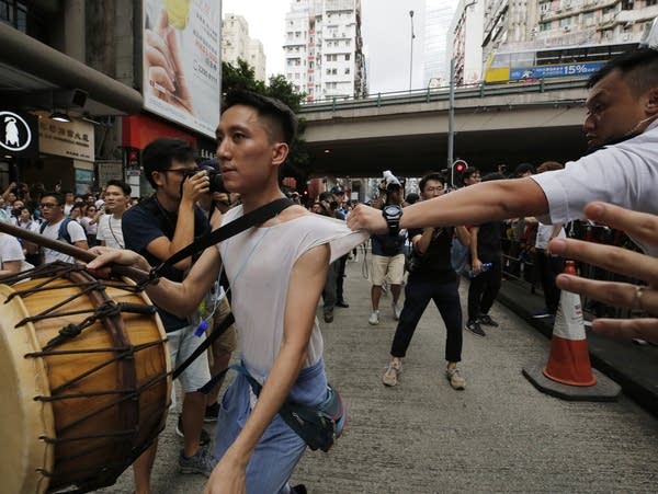 Protesters march along a downtown Hong Kong street