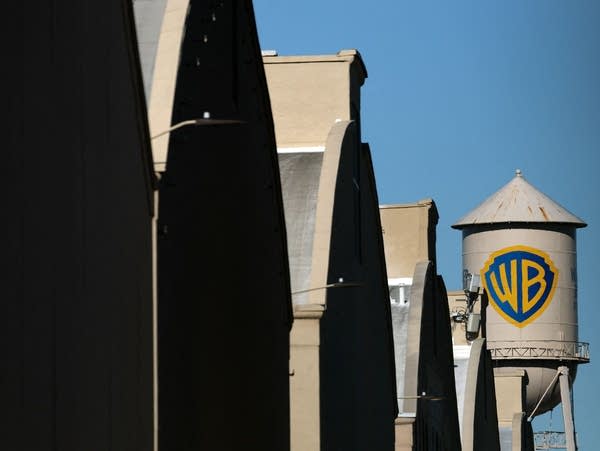The WB water tower is seen at Warner Bros. Studios, Burbank in Burbank, California on December 5, 2025. Streaming giant Netflix said December 5, 2025 it will buy film and television studio Warner Bros. Discovery for nearly $83 billion, the entertainment industry's biggest consolidation deal this decade. The acquisition gives Netflix access to a vast film catalog as well as the prestigious streaming service HBO Max. (Photo by Patrick T. Fallon / AFP via Getty Images)