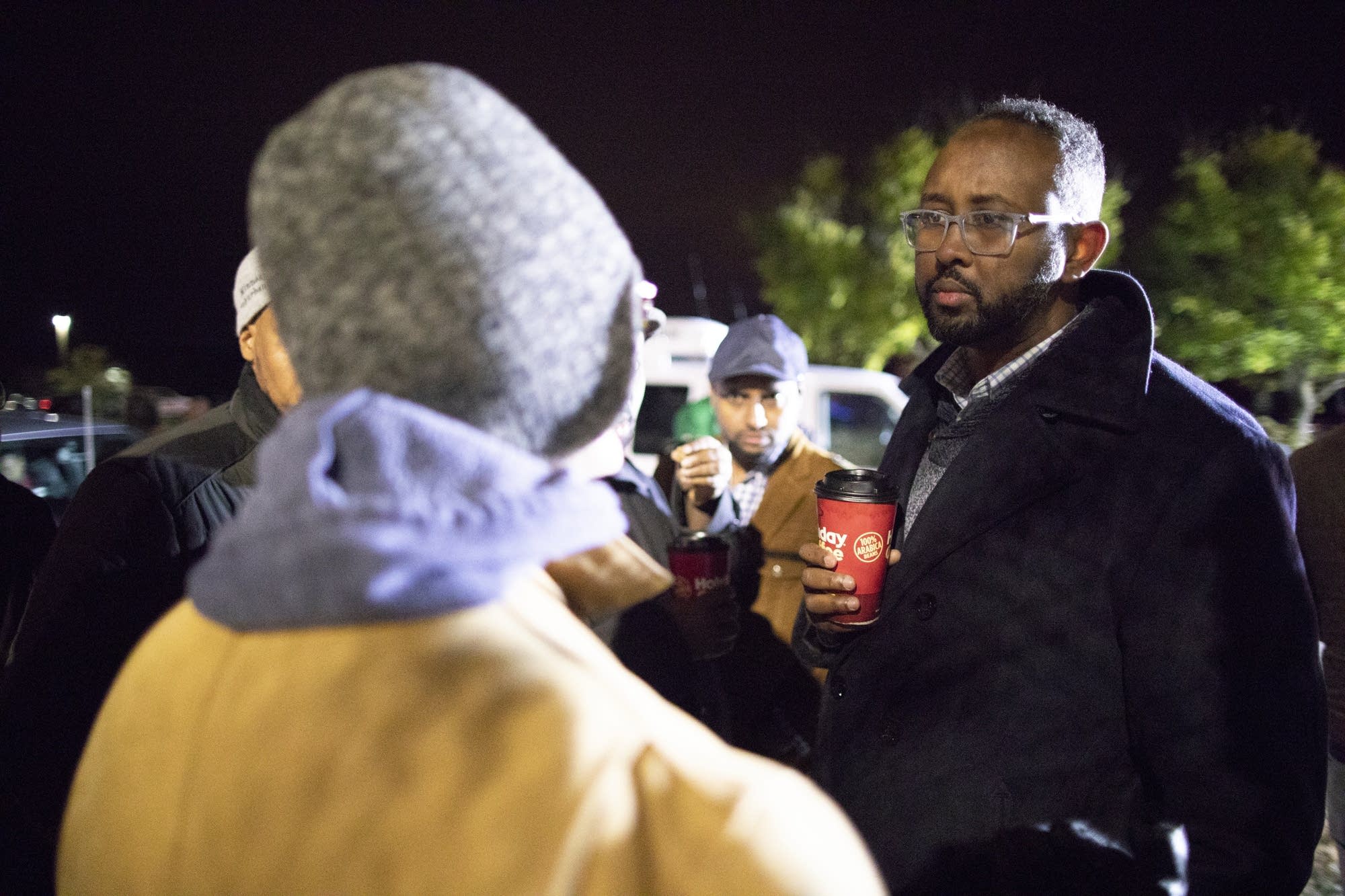 Jaylani Hussein, executive director of CAIR-MN, talks to police.
