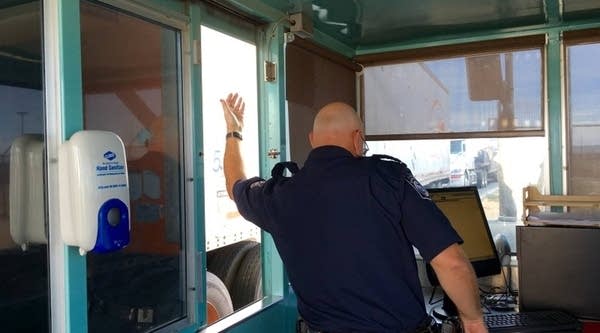 A U.S. customs officer waves a cargo truck through the port of entry in Santa Teresa, New Mexico. Dell is financing extended hours at this border crossing through an agreement with U.S. Customs and Border Protection.