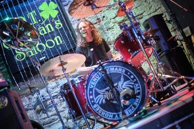 A musician plays drums onstage