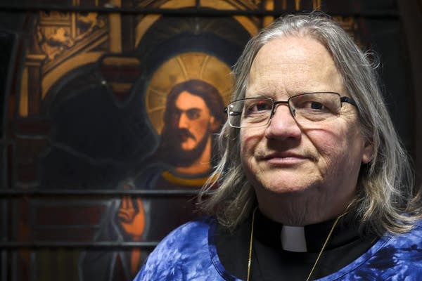 A reverend poses for a photograph.