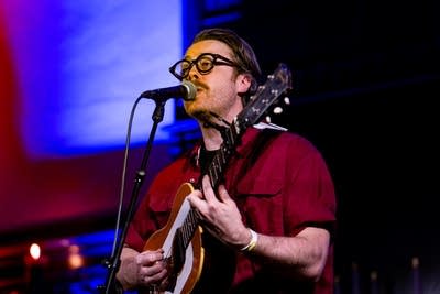Man singing and playing acoustic guitar