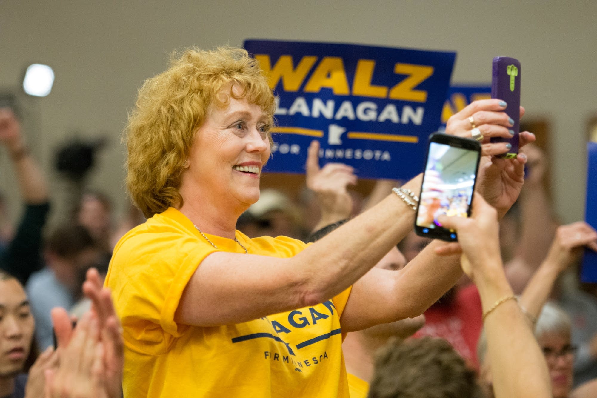 A supporter cheers while gubernatorial candidate Tim Walz speaks.