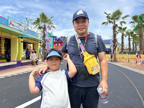Liao Zuyu poses with his six-year-old at Legoland Shanghai