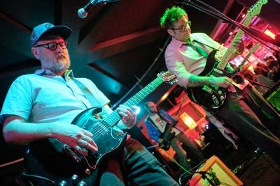 Two musicians performing onstage