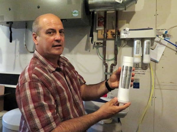 Bryan Buffington shows a filter from his reverse osmosis system.