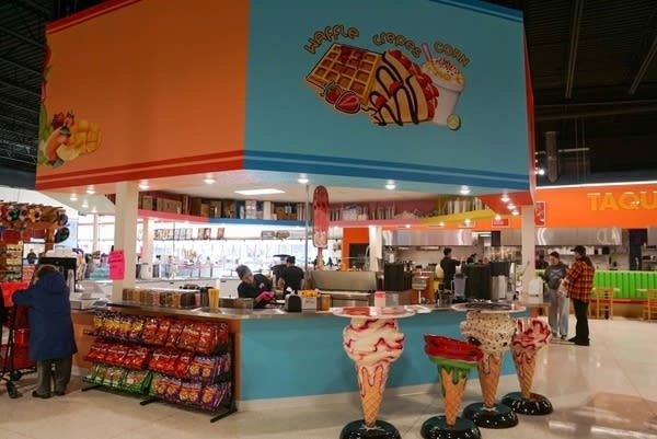 Wide shot of a dessert counter inside a market.