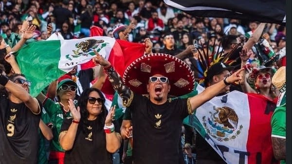 Javier Ochoa celebrates at a Mexico national team soccer game. A lifelong fan, Ochoa is worried he won't be able to see Mexico play at the World Cup on home turf this summer.