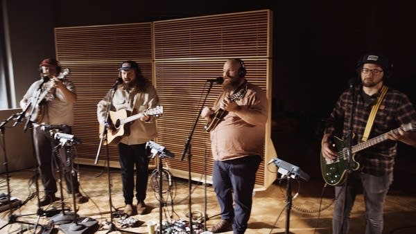 A band performing in a recording studio