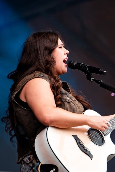 Gigi Perez and band on stage