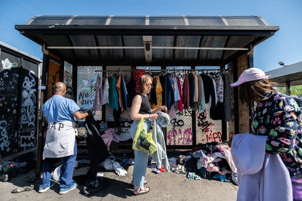 A woman brings clothes to a donation site