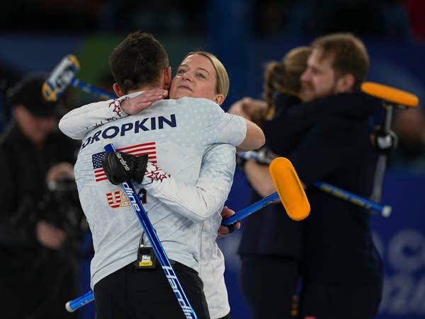 Curlers embrace after a match