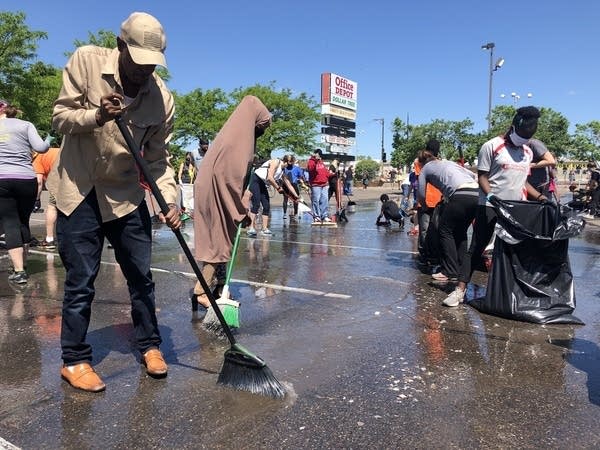 Volunteers gathered in Minneapolis Saturday morning, cleaning up the city's protest-worn streets, May 30, 2020.