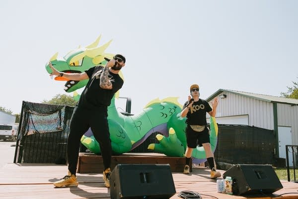 Two men performing on a small outdoor stage
