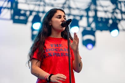 Samia performing on an outdoor stage.