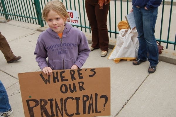 Dozens rally for ousted principal as lawmakers demand reinstatement