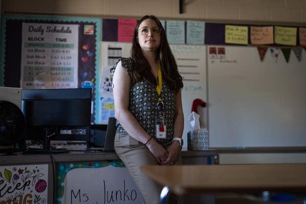 A teacher stands for a portrait in her classroom