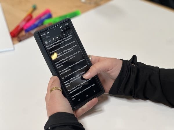 woman scrolls through phone
