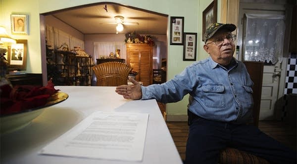 Rey Anzaldua, 73, sits in his cousin Fred’s dining room on Thursday, Jan. 31 2019, mulling over documents the federal government has sent the family seeking permission to build a wall on their land. He says the family will never sign over the rights and the government will have to take the land through eminent domain if a wall is going to be built on their property.