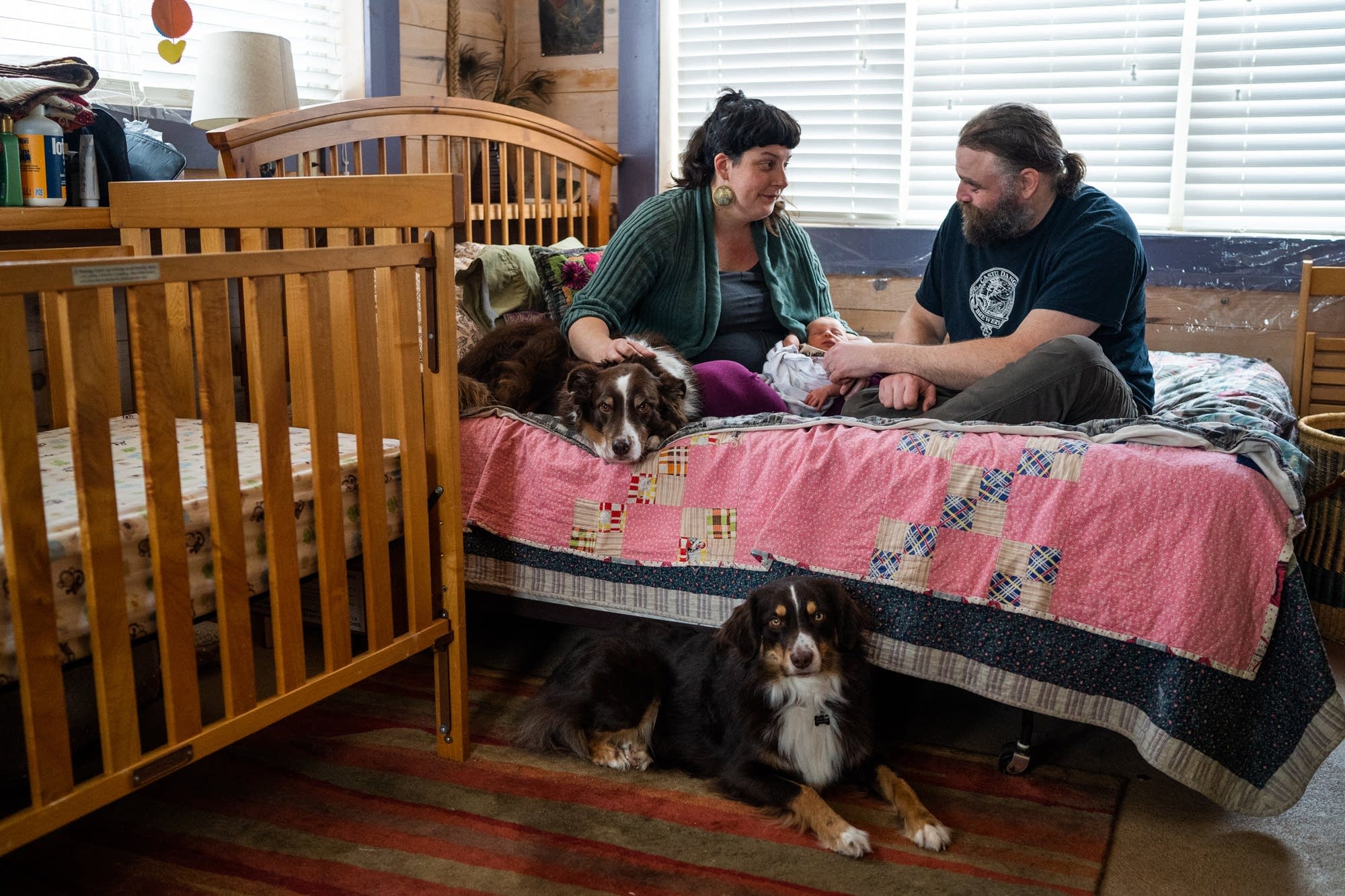 New parents Erin Petz and Matt Tyler sit with their newborn Corwyn