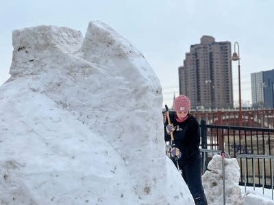 woman carving snow sculpture 