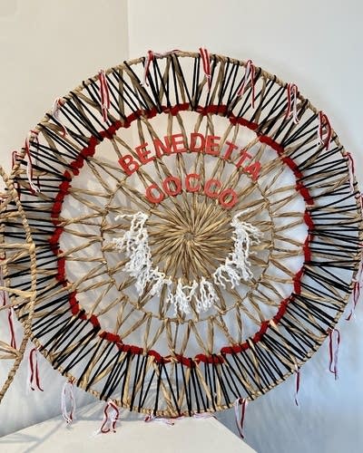 A textile work of art with the words "Benedetta Cocco."