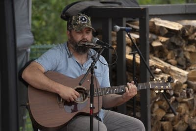 Eli Gardiner performing under tent