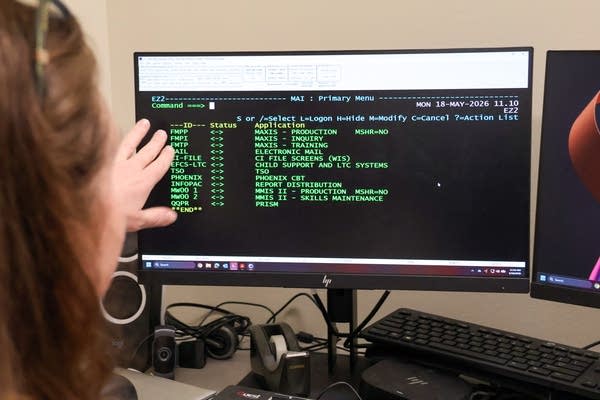 A woman points to a screen with text