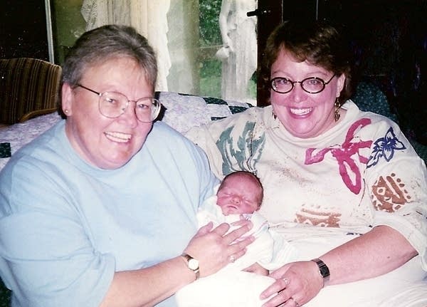 A photo of two people and a baby