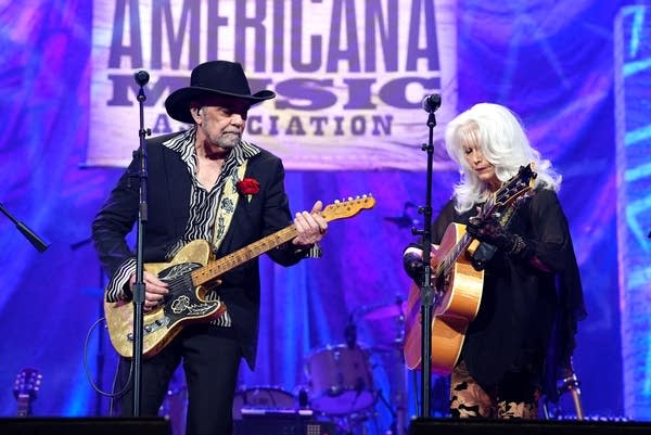 Two musicians perform onstage