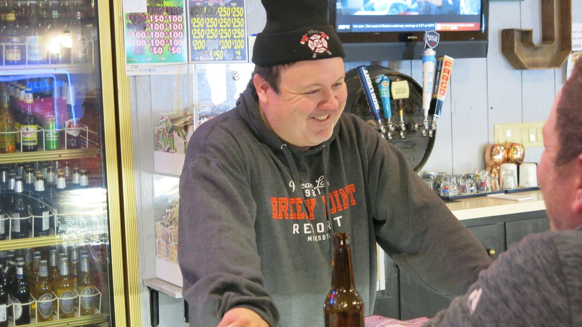 Fire chief and bar owner Cory Jamieson tends bar for his firefighters