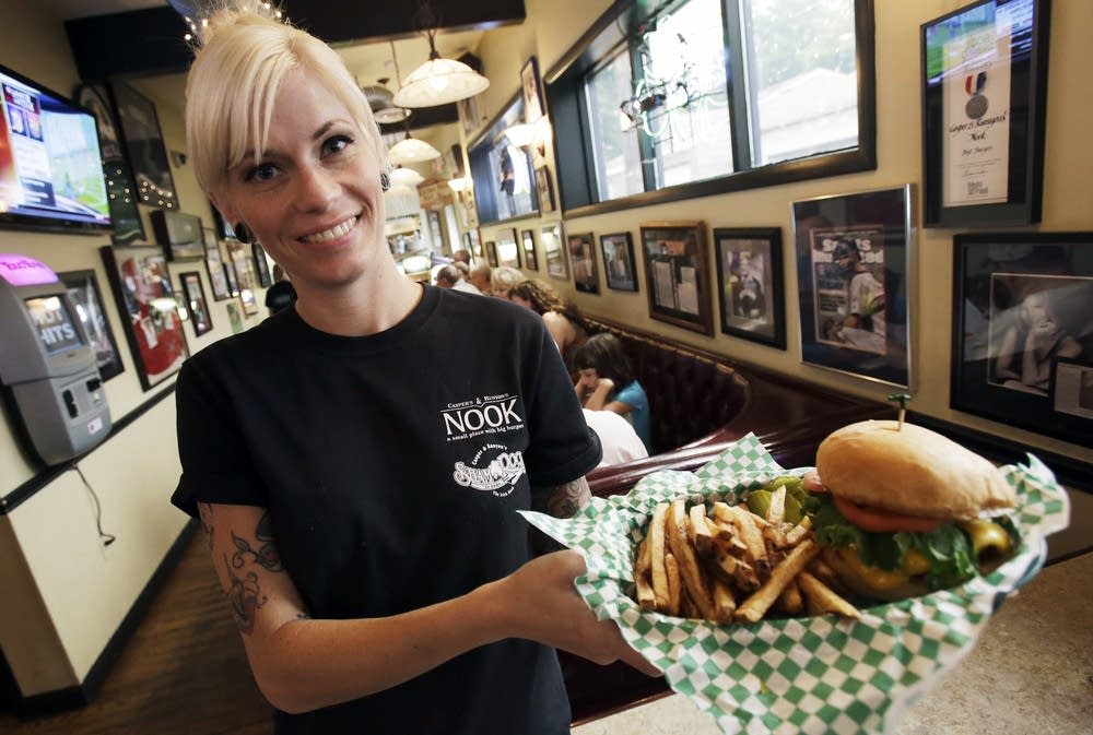 Server Taryn Yanez holds an order at The Nook