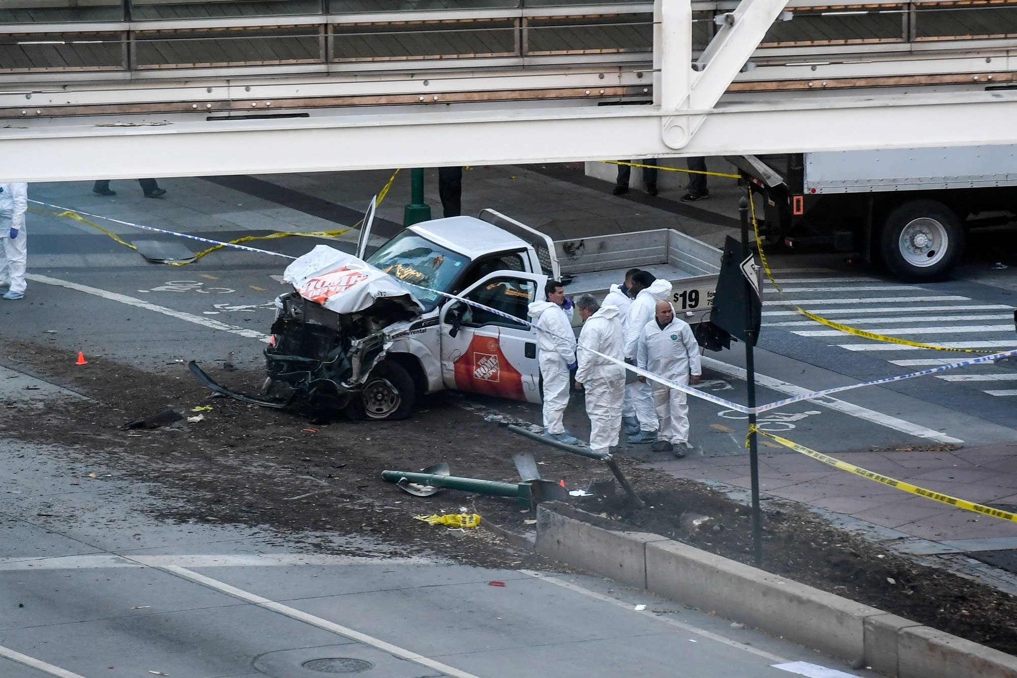 Investigators inspect a truck following the attack.