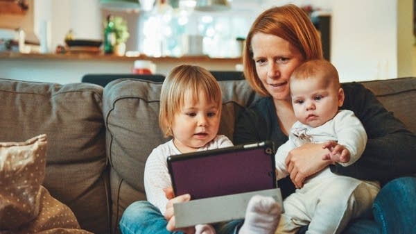 A family enjoys a tablet together.