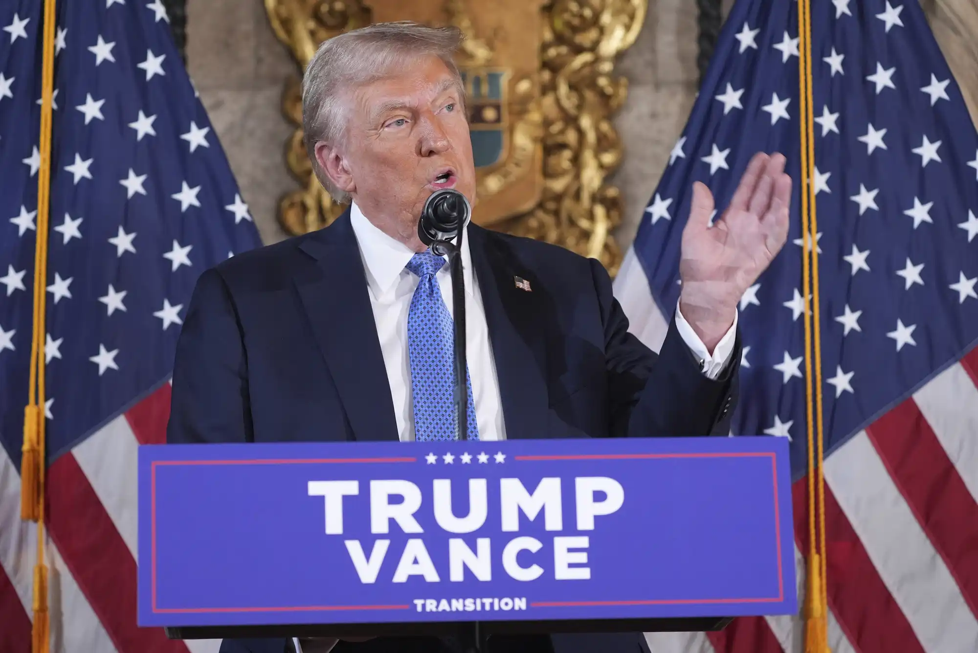 a man speaks at a podium